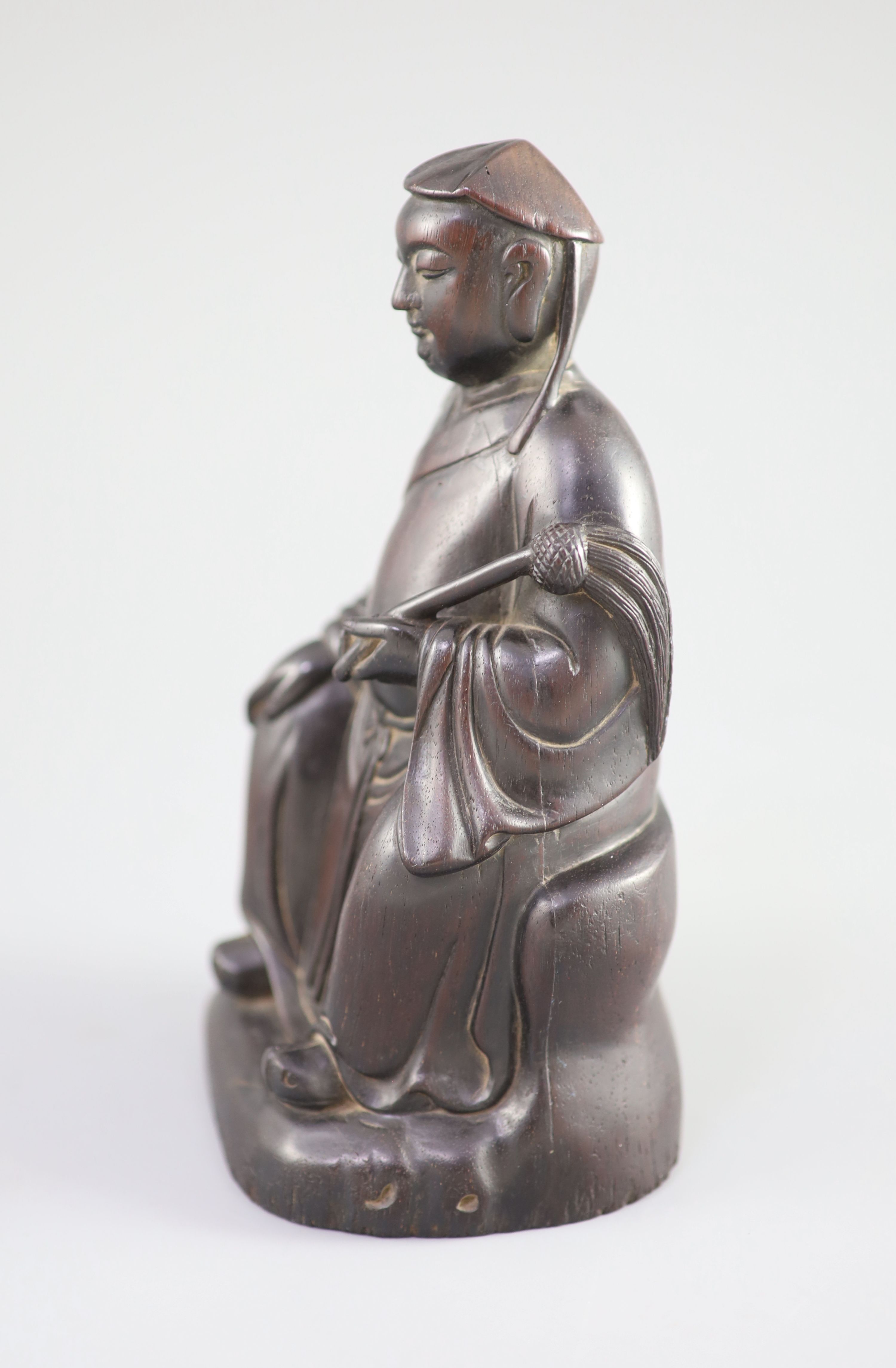 A Chinese Zitan seated figure of an official, 18th century, 19.3cm high